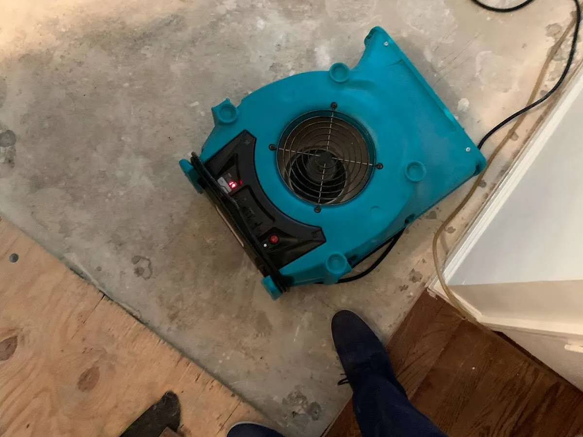 Air mover drying subfloor during Commercial Water Damage Restoration in Lubbock